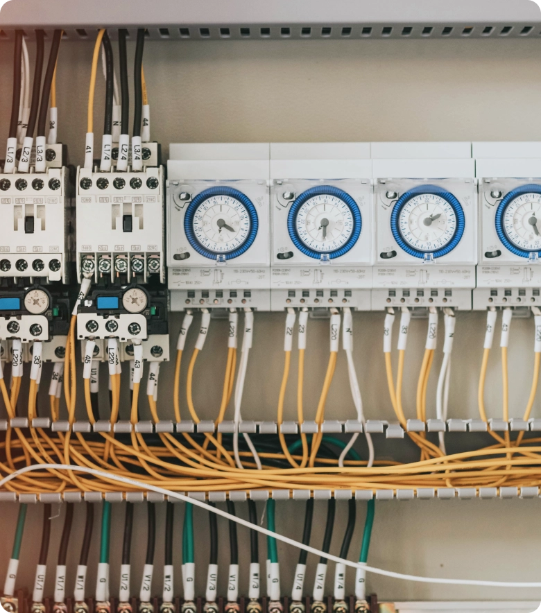 Close up of a control panel with multiple wires and meters, likely used for electrical wiring